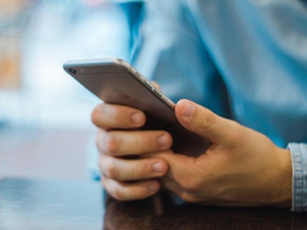 Man's hands holding a smartphone