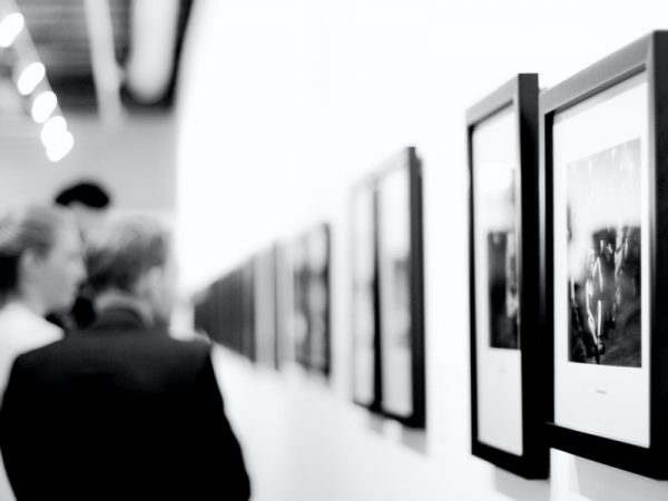 Man looking at photos in an art gallery